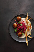 Black salsify and sesame cream with red cabbage and pomegranate salad and duck kofta