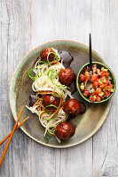 Glazed lamb meatballs in teriyaki sauce with udon noodles and cucumber and melon relish