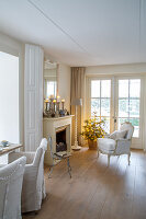 Living room with fireplace, armchair and small Christmas tree