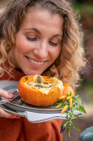 Woman serving stuffed pumpkin