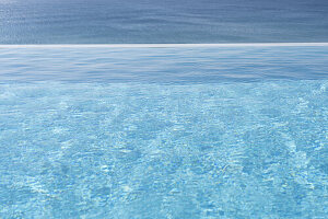 View of swimming pool and ocean in the background