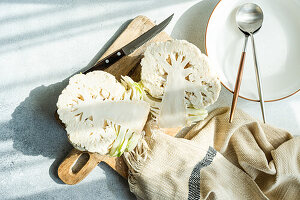 Raw cauliflower vegetable ready for cooking on concrete table