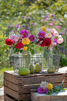 Blumensträuße aus Rosen (Rosa), Dahlien (Dahlia), wilde Möhre, Herbstanemone (Anemone Japonica) mit Birnen im Drahtkorb