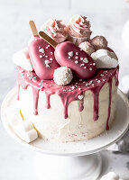Ruby chocolate drip cake with sweets
