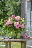 Bouquet of dahlias (Dahlia) and summer lime on garden table