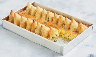 Baked spinach and ricotta triangles with courgettes