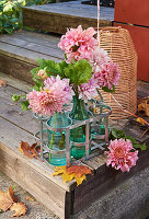 Autumnal flowers in bottles