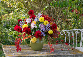 Bouquet of dahlias (Dahlia), asters (Aster), wild grape and rose hips