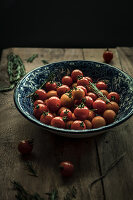 Bowl of cherry tomatoes on a rustic wooden table