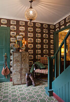 Entrance area with retro tiles, green painted staircase and vintage wallpaper