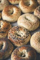 Various bagels sprinkled with sesame and poppy seeds