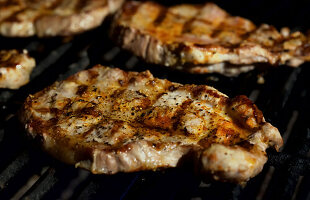 Close-up of pork shoulder steaks on the grill