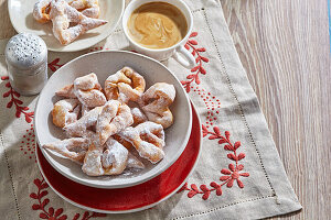 Deep-fried pastries with icing sugar, coffee