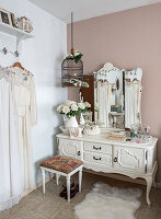 Vintage dressing table with white roses and antique mirror