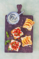 Toast with ricotta cream, peaches and tomatoes
