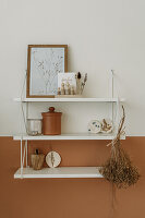 Wall shelf with dried flowers, ceramics and picture