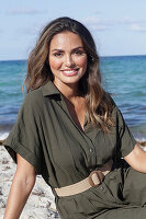 Woman in khaki coloured dress on the beach