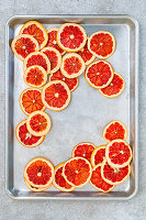 Dried grapefruit slices on a baking tray