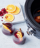 Mulled wine from the slow cooker with orange and pomegranate seeds