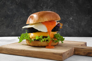 Burger with beef, cheese, black pudding and fried egg