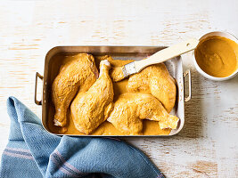 Marinated chicken drumsticks in a baking dish