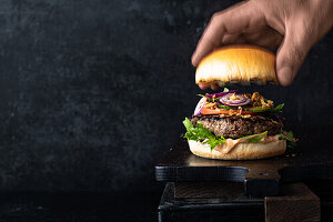 Juicy burger with onions and salad