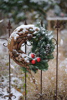 Winter wreath made from cones and fir greenery on a wrought iron fence