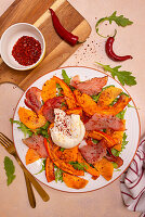 Rocket salad with baked pumpkin, Italian ham, burrata and chilli