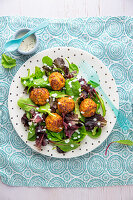 Leaf salad with meatballs and soy dressing