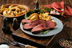 Beef steak with baked potatoes and herbs