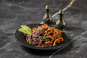 Black rice noodles with fried prawns and vegetables