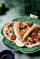 3 shrimp tacos with coleslaw and lime and cilantro