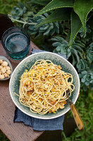 Spaghetti with anchovies, lemon zest and hazelnuts