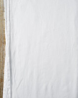 White tablecloth on wooden table - background