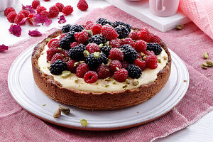 Berry tart with vanilla cream and pistachios