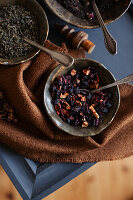 Bowls with tea, dried rose petals and fruit