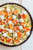 Raw quiche with courgette, salmon, mozzarella and feta