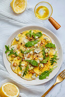 Carpaccio of pears with blue cheese, rocket and walnuts