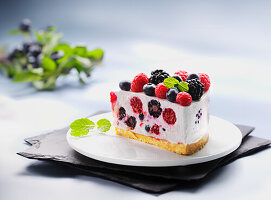 A slice of cream cheese cake with fresh berries