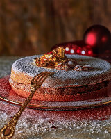 Gâteau aux noix with gold leaf and icing sugar