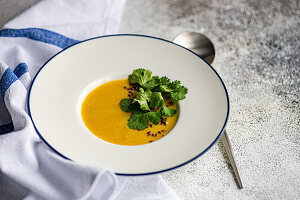 Kürbiscremesuppe mit Leinsamen und Korianderblättern