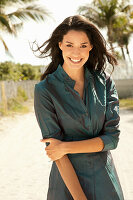 Young woman in emerald green blouse dress