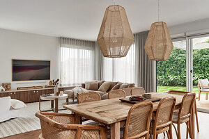 Dining area with rattan chairs in open-plan living room