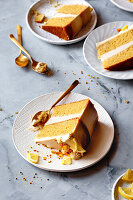 A beautifully decorated lemon layer cake on a marble background