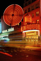 Cabaret in neon lights at night in Paris; Paris, France