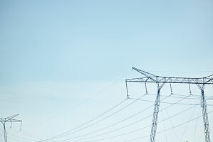 Low angle view of electricity pylon against blue sky