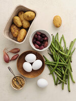 Ingredients for vegetarian dishes - potatoes, eggs, olives, beans