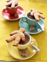 Gingerbread men on cups of coffee