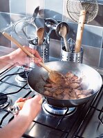 Stir frying pork in pan