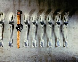 line of forks plus swatch watch